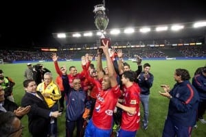 soccer team holding up trophy after winning