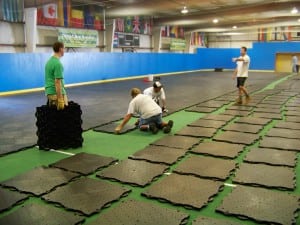 installation team puts together ultrabasesystems base panels for indoor soccer field