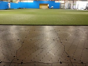 close up view of artificial turf and base panels for indoor soccer field installation