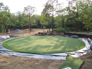 artificial turf installed on base panels for circular putting green